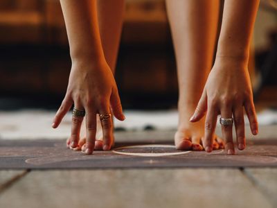 Close-up of feet on a yoga mat, suggesting grounding and stability.
